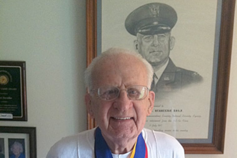 Frank Herrelko, 98, of Lower Gwynedd, with some of the 350 medals he has won in senior athletic competition. (Art Carey / Staff)