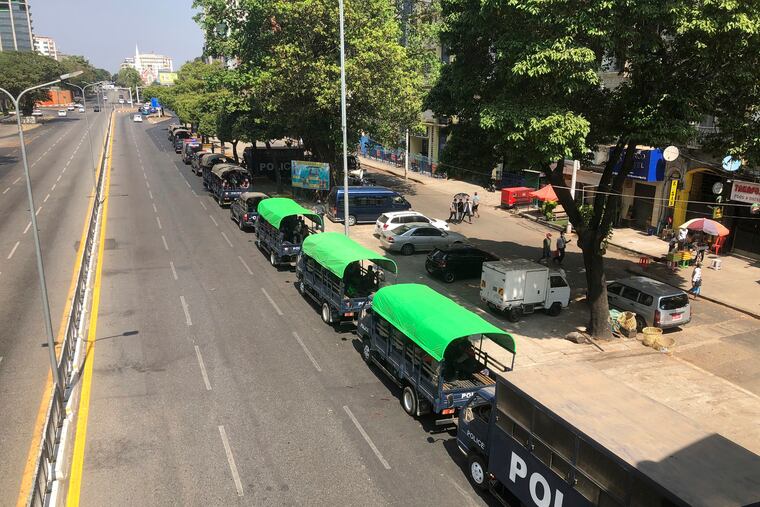 Police trucks are parked at Kyauktada police station in Yangon, Myanmar on Monday.