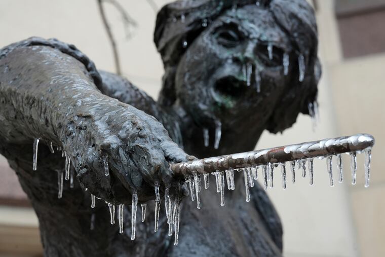Icicles hang from the Angelina Eberly statue in downtown Austin, Texas, during a winter storm.