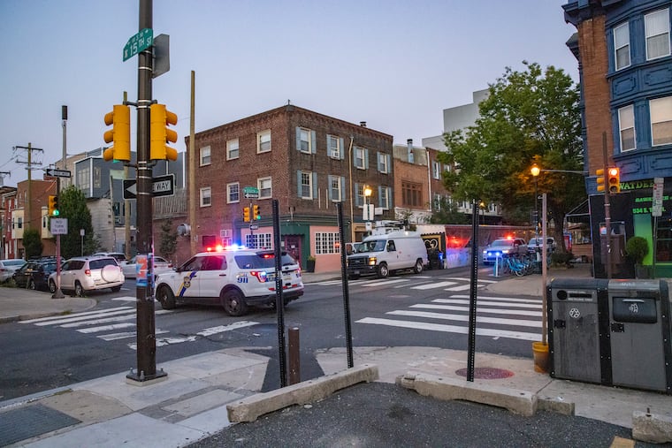 Philadelphia police block traffic at South Street and 15th Street as they guard the area around a fatal hit-and-run early Wednesday morning, July 28, 2021.