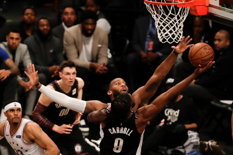 Sixers center Greg Monroe goes after Brooklyn Nets forward DeMarre Carroll attempt during the third-quarter in game three of the Eastern Conference playoffs on Thursday, April 18, 2019 in Brooklyn.