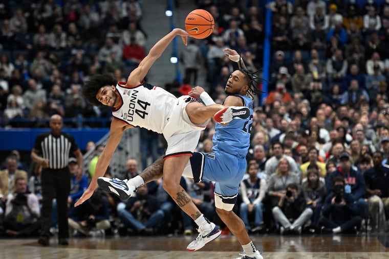 UConn's Andre Jackson Jr. (44) and Villanova's Cam Whitmore collide as they pursue a pass during the first half in Hartford, Conn.