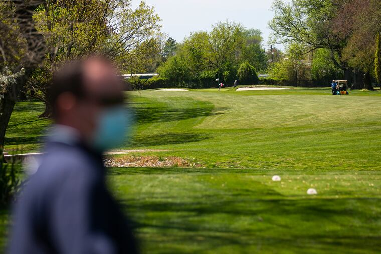 Ethan Pauxtis, 46, of Westampton, N.J., looks out across the Merchantville Country Club golf course as members practice social distancing while playing a round on Saturday afternoon. Games are scheduled times and are separated by a 16 minute interval before members can start.