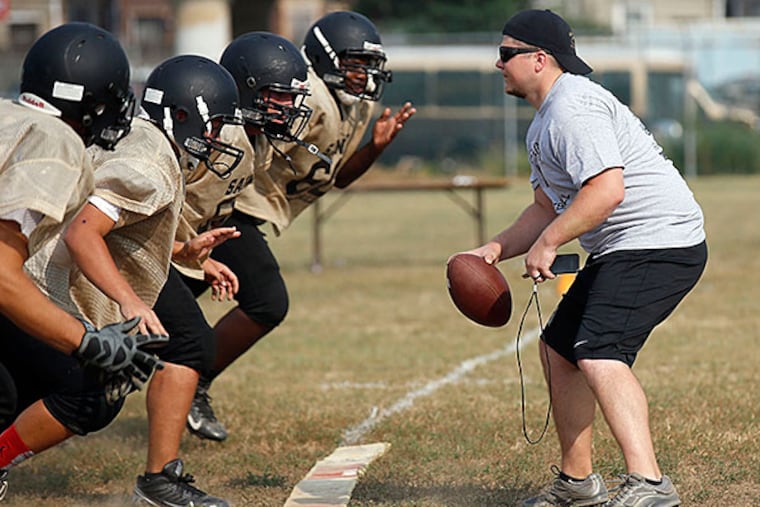 Neumann-Goretti High School Head Football Coach Dan Concannon practices with his team at McNichol Field in South Philadelphia on Wednesday, September 2, 2015. Concannon will debute against his former team, Valley Forge Military Academy and his brother on Saturday.