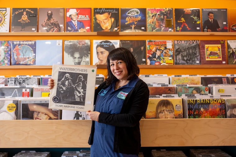 Lisa Schaffer, owner of Vinyl Chickie, with an LP from the collection of late Philly DJ Pierre Robert, in her vinyl record store in Glenside this month.