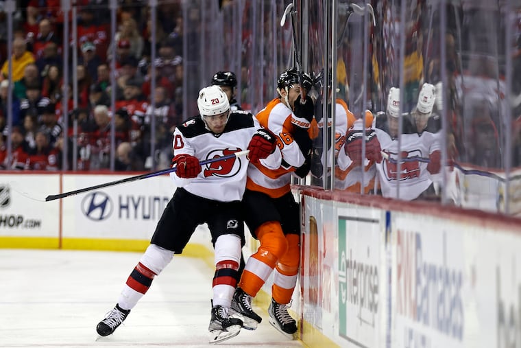 New Jersey Devils center Michael McLeod (left) checks Flyers left wing Joel Farabee during the first period. Neither team scored in the period, but the Devils opened the floodgates in the second.