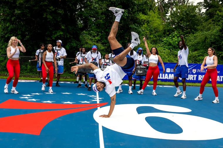 76ers entertainment team member Najee Rose performs with the Dancers, Dunk Squad and Drum Line during ribbon-cutting ceremonies at the newly refurbished Rufus Williams Court in Cobbs Creek Wednesday, Jun. 18, 2025. The Sixers and Penn Medicine teamed up to spruce up the neighborhood basketball courts.