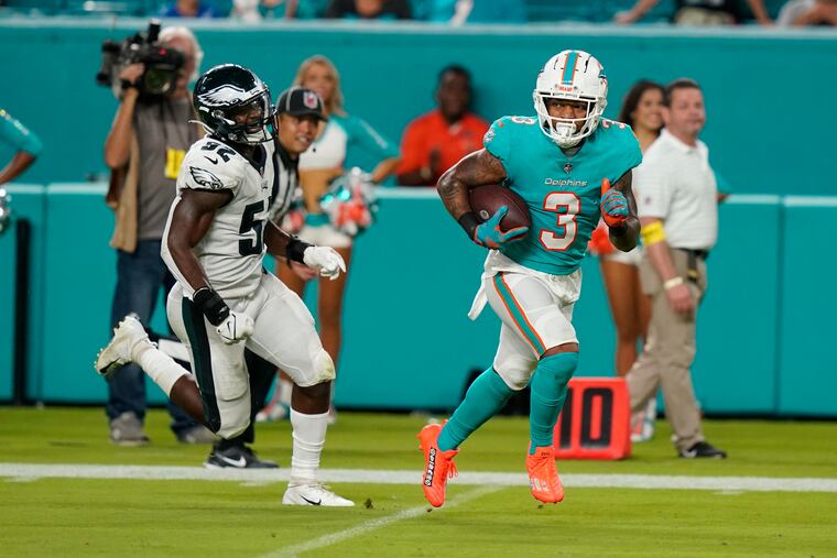 Miami Dolphins wide receiver Lynn Bowden Jr. runs for a touchdown ahead of Eagles linebacker Davion Taylor during a preseason game on Aug. 27.