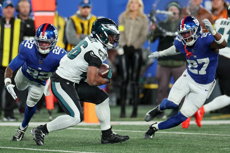 Giants defenders surround Eagles running back Saquon Barkley during their previous matchup on Oct. 9.