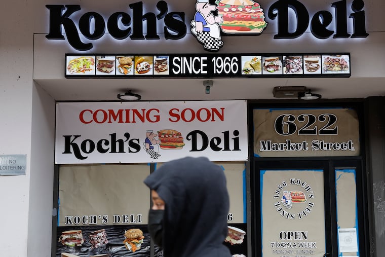 A pedestrian walks near the soon-to-open Koch's Deli on the 600 block of Market Street on March 14, 2024.