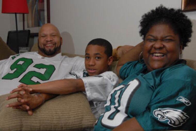 11-year-old Trevon Walker, center, is spending his first Christmas as
an adopted child in the family of Ebon, left, and Janelle Walker, of
Maple Shade, NJ. ( Photo / Curt Hudson )