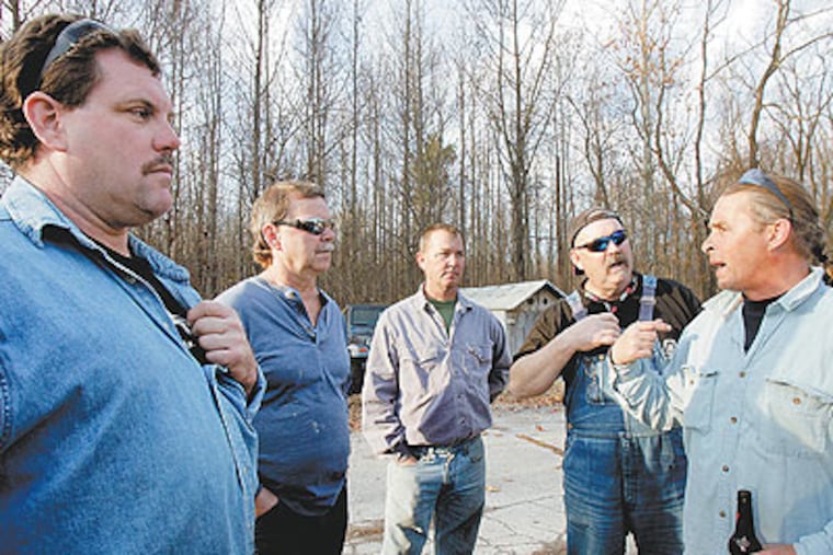 Contract workers (from left) Glenn Hash, 47; Bill Dorman, 54; Jim Pribish, 47; Jerry Gallagher, 57; and Bob Lyon, 46, a contract pipefitter, commiserate in the parking lot of The Red Lion Inn in Bear, Del., a few miles from the the closing Valero plant. (Bonnie Weller / Staff Photographer)