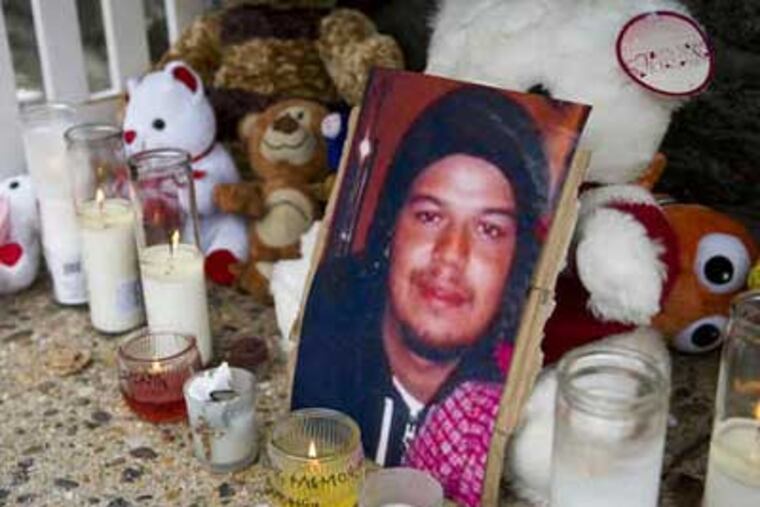 A photo of victim Shane Ferguson is propped up in a makeshift memorial created for him and his mother, Dorothy Flora. (Kriston J. Bethel / Staff Photographer)