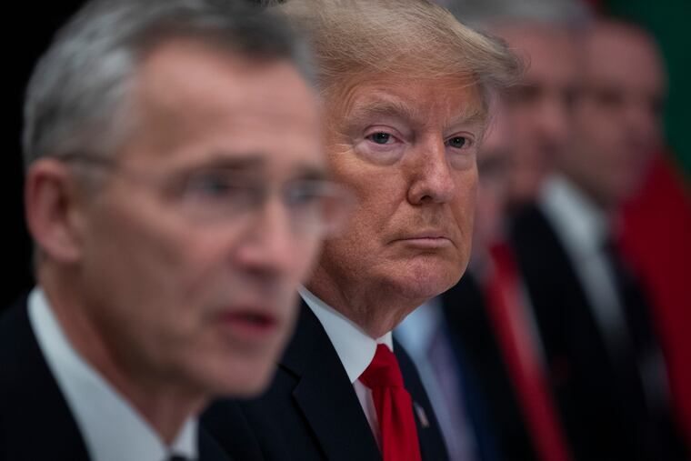 Donald Trump listens as then-NATO Secretary General Jens Stoltenberg speaks during a 2019 working lunch in Watford, England, with NATO members that had met their financial commitments to the organization.