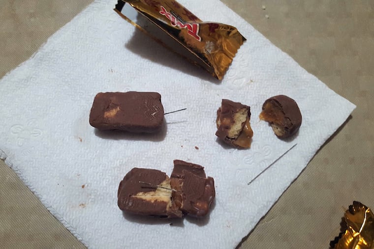 Several pieces of candy were found with needles inside, police said. No injuries were reported.