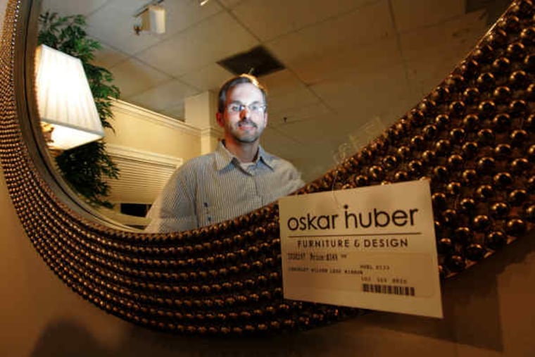 Ron Huber in a reflection at the Southampton store. "It certainly is a concern . . . how much the reputation was affected," he said.