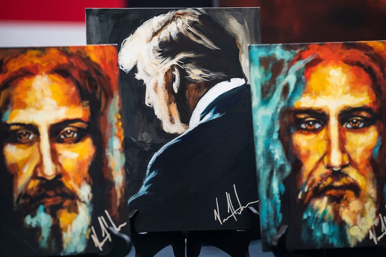 Artwork of President-elect Donald Trump sits for sale alongside portraits of Jesus Christ at the Conservative Political Action Conference in March 2023.