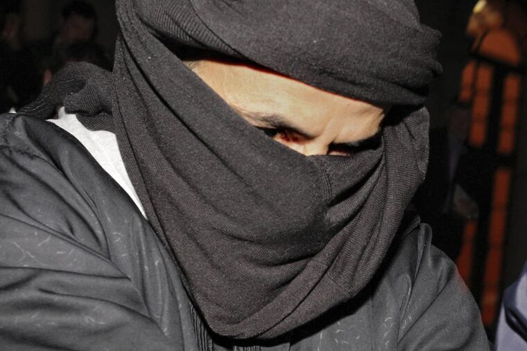 In this March 15, 2010, file photo, Ali Charaf Damache arrives at the courthouse in Waterford, Ireland. Damache, an al-Qaeda suspect known as Black Flag who has been linked to a plot to kill Swedish cartoonist Lars Vilks, pleaded guilty to terrorism related charges Monday in federal court in Philadelphia.