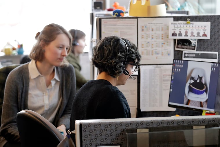 Public health nurse Jennifer Morgan, right, checks-in via phone with a patient self-quarantined at home who had some risk of exposure to the coronavirus as University of Washington epidemiology student Erika Feutz observes at the public health agency for Seattle and King County.