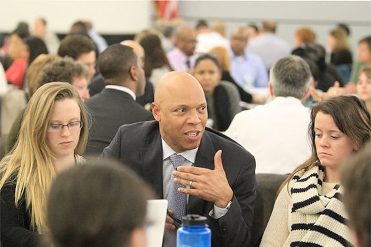 Philadelphia School Superintendent William R. Hite Jr. talks with one of the groups at Monday night's meeting. ( CHARLES FOX / Staff Photographer )