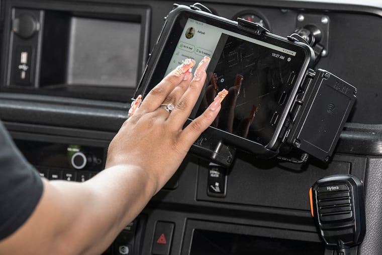 Bus driver Aaliya Horn operates a computer tablet installed in her bus during a training session aboard one of the Philadelphia School District's new school buses in Philadelphia on Tuesday, July 28, 2026. The district's new bus vendor is introducing high-tech buses equipped with air conditioning, onboard cameras and GPS technology that allows parents to track their children's buses in real time.