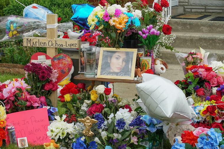 A memorial of flowers, balloons, a cross and photo of victim Marlen Ochoa-Lopez, are displayed on the lawn, Friday, May 17, 2019 in Chicago, outside the home where Ochoa-Lopez was murdered last month. Assistant State's Attorney James Murphy says a pregnant Ochoa-Lopez, who was killed and whose baby was cut from her womb, was strangled while being shown a photo album of the late son and brother of her attackers.