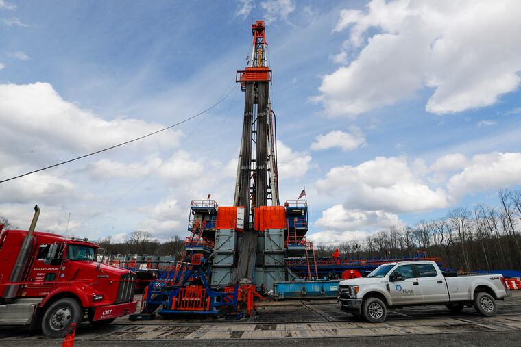 In this photo from March 12, work continues at a shale gas well drilling site in St. Mary's, Pa.