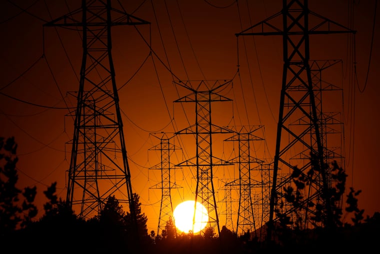 The sun sets behind electric power lines in the Porter Ranch section of Los Angeles in September 2024.