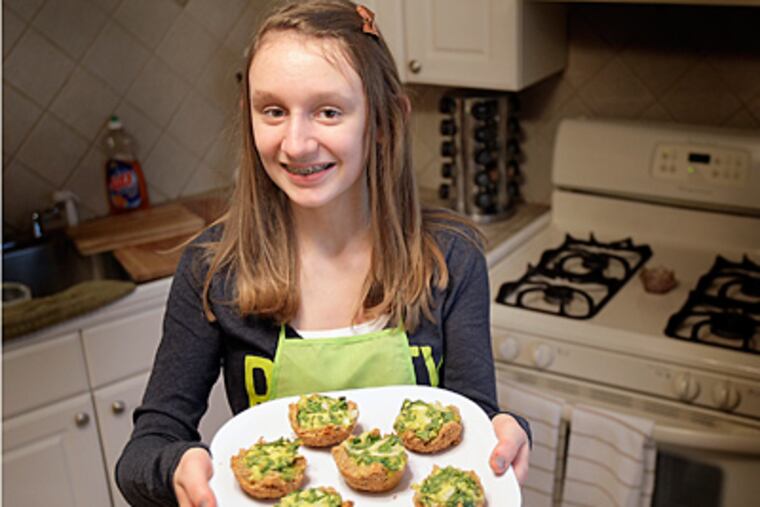 Kelsey O'Callaghan, 13, of Bensalem, Pa., has been named PETA's
"Compassionate Kid." She makes videos as the "Veggie Chef" that show
her peers how to be vegetarian and posts them on YouTube. She is seen here
in her family's kitchen with a vegetarian souffle. (David Maialetti /
Staff)