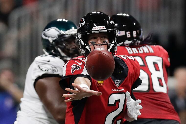 Falcons quarterback Matt Ryan pitches the football to a running back in a 2019 game against the Eagles.