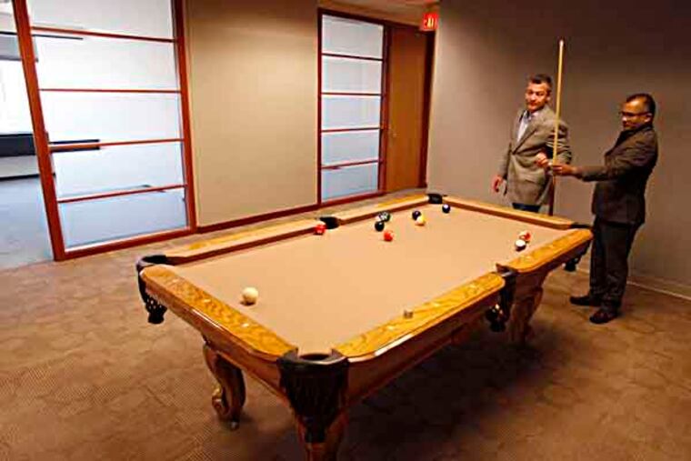 Christopher Doggett (left) and Christopher Gali (right) play some pool in Adminovate, a company they started to create insurance administrative software. ( MICHAEL S. WIRTZ / STAFF PHOTOGRAPHER ). May 1, 2013.