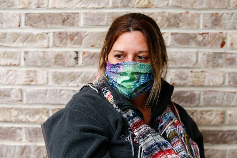 Marie Ryan wearing her mask while sitting outside her Berlin Borough, N.J. home on May 8. Ryan's brother, Joseph Pearson has tested positive for the COVID19 virus while living at the New Lisbon Developmental Center, a home for people with developmental disabilities in the Pine Barrens.