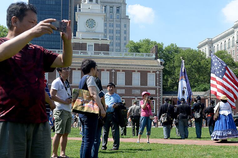 Tourist on Independence Mall snap photos during a Flag Day parade from the National Constitution Center to Independence Hall June 14, 2015. (TOM GRALISH / Staff Photographer)