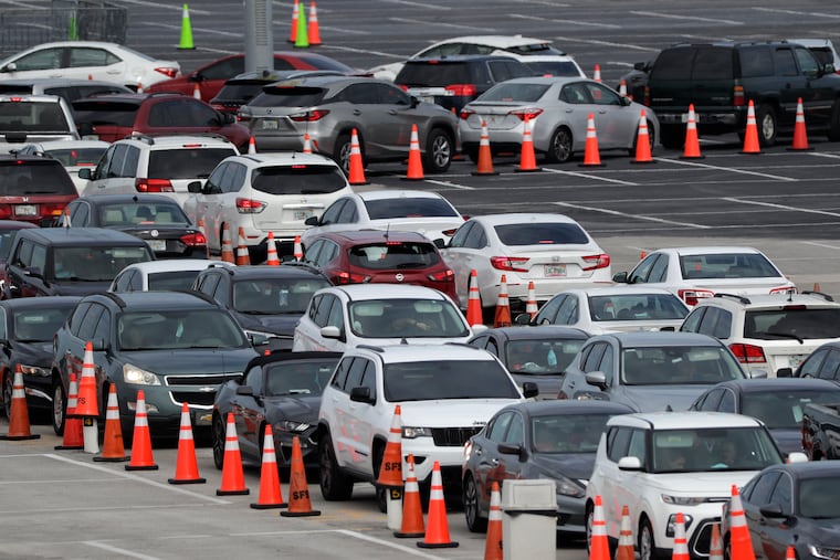 In Florida, which reopened early with few precautions against the coronavirus, more than 200,000 people have tested positive. Lines of cars waited at a drive-through coronavirus testing site on July 5 outside Hard Rock Stadium in Miami Gardens. (AP Photo/Wilfredo Lee)