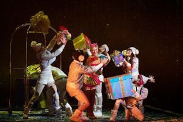 Performers carry gifts from a hotel cart in Cirque du Soleil's "Twas the Night Before...". The holiday show is coming to Philadelphia in December.