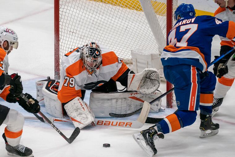 Flyers goaltender Carter Hart (79) blocks a shot by New York Islanders right winger Leo Komarov (47) during the third period Saturday at Nassau Coliseum. Hart played solidly, but the Flyers lost in a shootout, 3-2.
