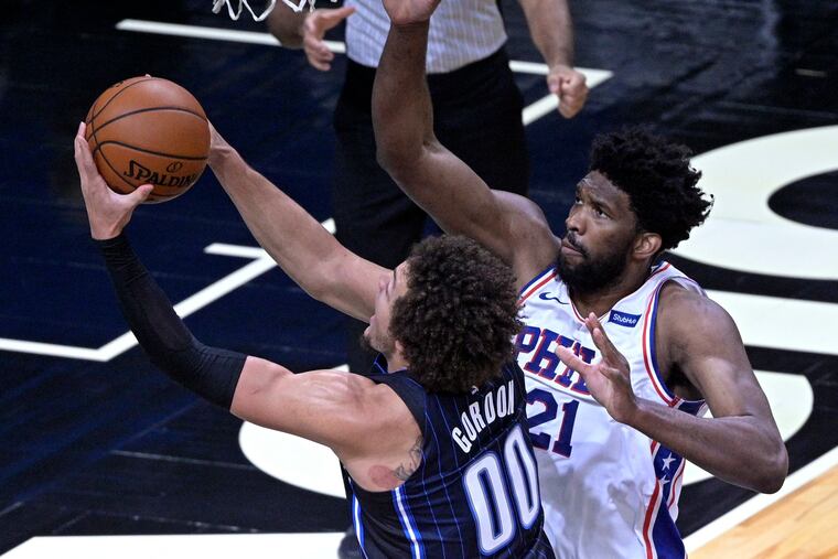 Magic forward Aaron Gordon (left) goes up for a shot in the first half in front of 76ers center Joel Embiid on Thursday.