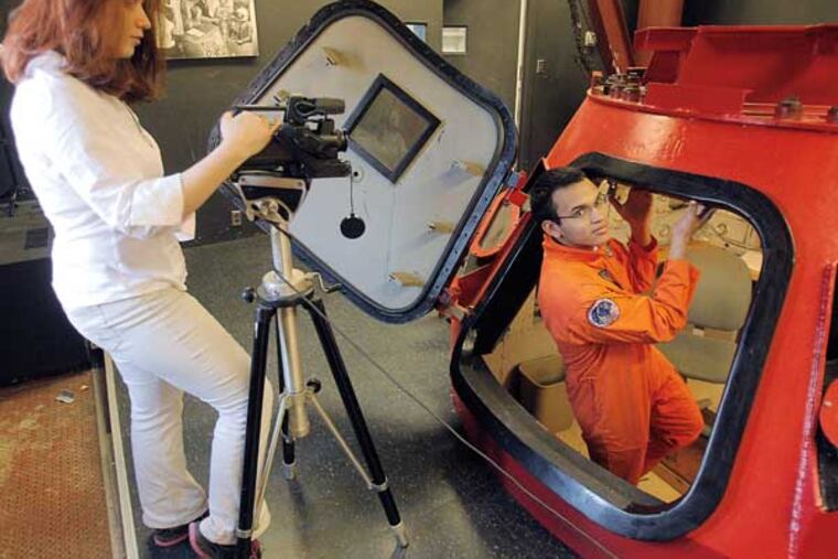 Jessica Hattina,18 is video taping Ramon Contreras, 18 is coming out a Apollo One Capsule Simulator donated by NASA.
01-17-2014 (AKIRA SUWA / Staff Photographer)