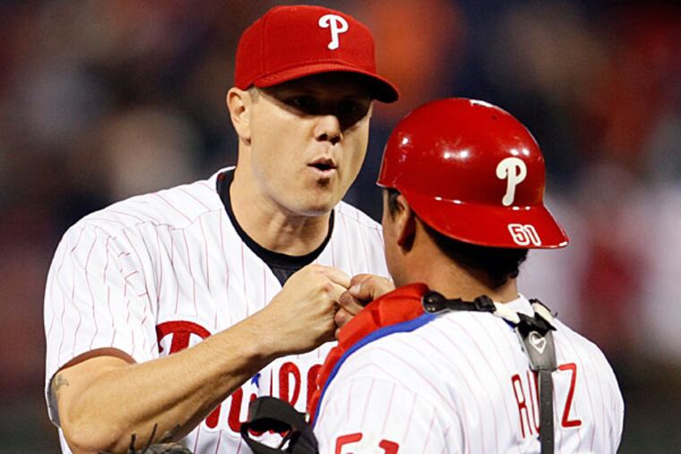 Jonathan Papelbon, left, and catcher Carlos Ruiz celebrate at the end of a baseball game against the Miami Marlins, Friday, April 11, 2014, in Philadelphia. The Phillies won 6-3. (Tom Mihalek/AP)