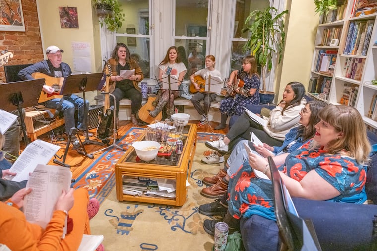 Mark Engler, (far left) co-founded the Getaway Choir with his 12-year-old daughter, Cylvia. The group only performs Taylor Swift songs and has met monthly in Engler's Spruce Hill apartment to prepare for an Eras Tour-style concert at Studio 34 on Jan. 11, 2025.