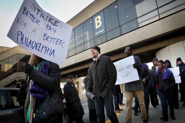 Workers with PrimeFlight at Philadelphia International Airport stage a protest outside terminal on Thursday, November 20, 2014. ( ALEJANDRO A. ALVAREZ / STAFF PHOTOGRAPHER )