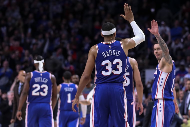 Sixers forward Tobias Harris and JJ Redick celebrate after a made three-pointer by their teammate Mike Scott in a 2019 game.