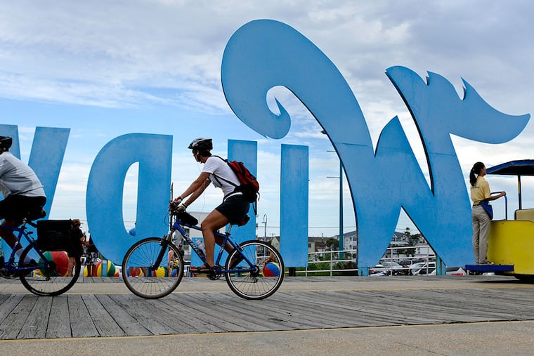Biking on the Boardwalk in Wildwood, where a scenic bike route runs nearly the entire length of the 5-mile island, beginning in Wildwood Crest. ( TOM GRALISH / Staff Photographer )