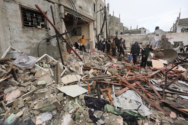 Palestinians look at destruction after Israeli strikes on Rafah, Gaza Strip on Wednesday.