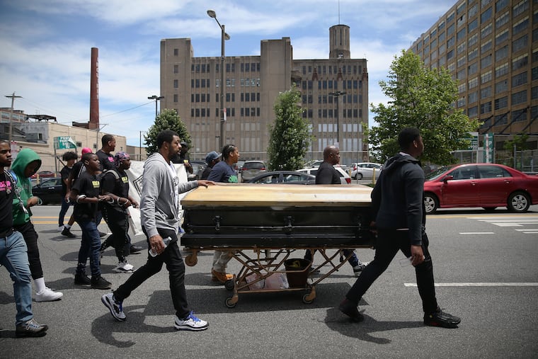 Activists (from left) Darryl Booker, Fatimah Martin, Terry Starks, and Yaddi Jones wheel a casket down North Broad Street toward City Hall in Philadelphia as they march against gun violence and other issues on Tuesday, May 21, 2019. The "Rise Up Break the Chains Youth March," organized by 13-year-old Ryshee Shaw, went down Broad Street from York Street to City Hall on election day to bring attention to bullying, gun violence, mass incarceration, mental health, substance abuse, racial profiling and youth homelessness.