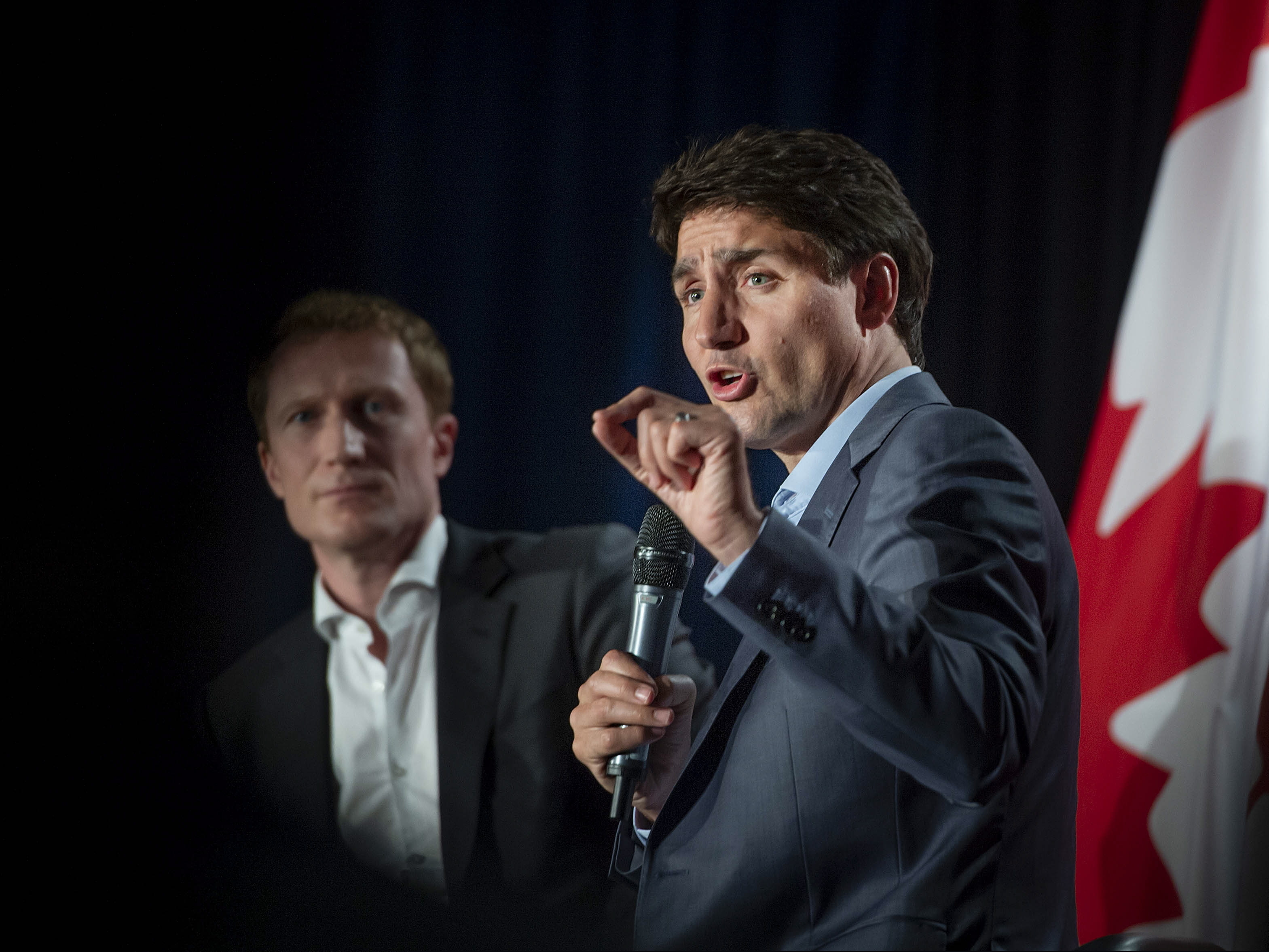 Canadian Prime Minister Justin Trudeau speaks to supporters as Marc Miller, MP of Ville-Marie-Le Sud-Ouest-Ile-des-Soeurs, looks on during an armchair discussion at an open Liberal Party fund-raising event in Montreal, Quebec, Monday, June 17, 2019.