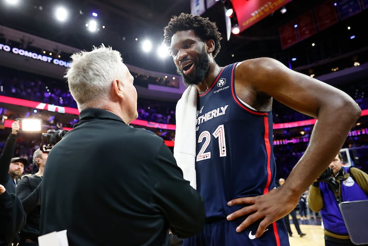 Joel Embiid with San Antonio assistant coach and former Sixers head coach Brett Brown after the Sixers beat the Spurs on Monday.