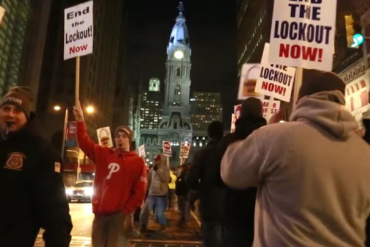 Members of the Carpenters Union protest outside the Philadelphia Convention Center during a black tie event for the Philadelphia Auto Show.
