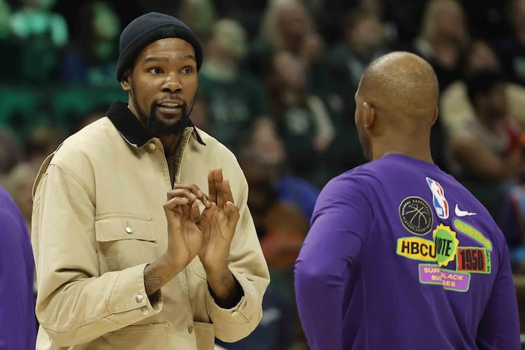 Kevin Durant talks with new Phoenix Suns teammate Chris Paul during a game last month. Durant is schedule to make his Suns debut Wednesday night against the Charlotte Hornets.