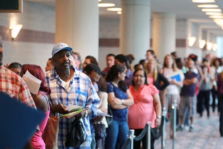 Anthony Turner, a Harrahs employee, looks for a new job at the New Jersey Labor and Workforce Development career fair in Atlantic City on Wednesday, September 10, 2014. ( DAVID SWANSON / Staff Photographer )